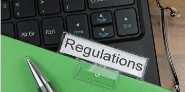 Folder named "regulations" on top of a computer keyboard