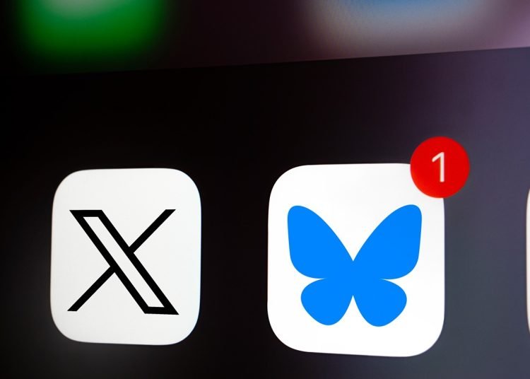 Dhaka, Bangladesh- 26 Nov 2024: A close up of an iPhone screen displaying the X (twitter) app icon and the Bluesky app icon.