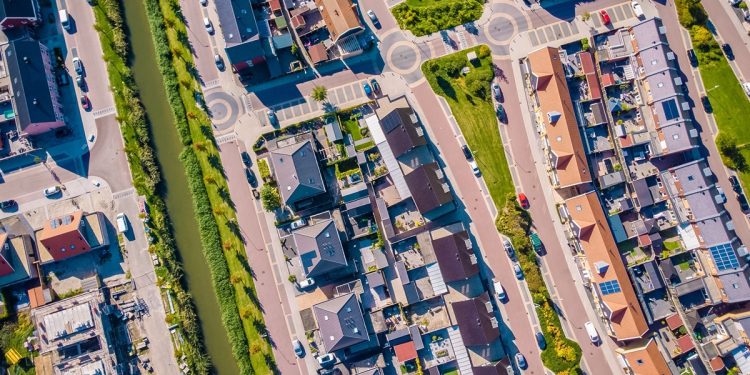 Drone view of Dutch suburban area with modern family houses.