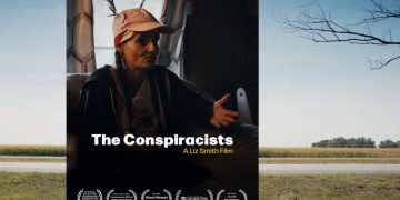 a film poster of a woman in a baseball cap