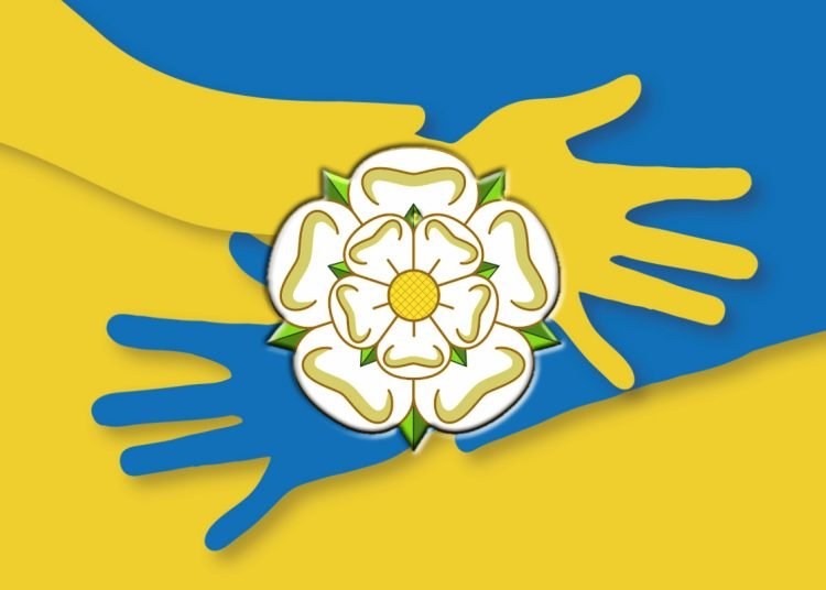 hands crossing over each other in colours of Ukraine flag (blue and yellow) with a white Yorkshire rose on top of the hands