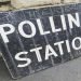 a large black sign with the words polling station printed in white