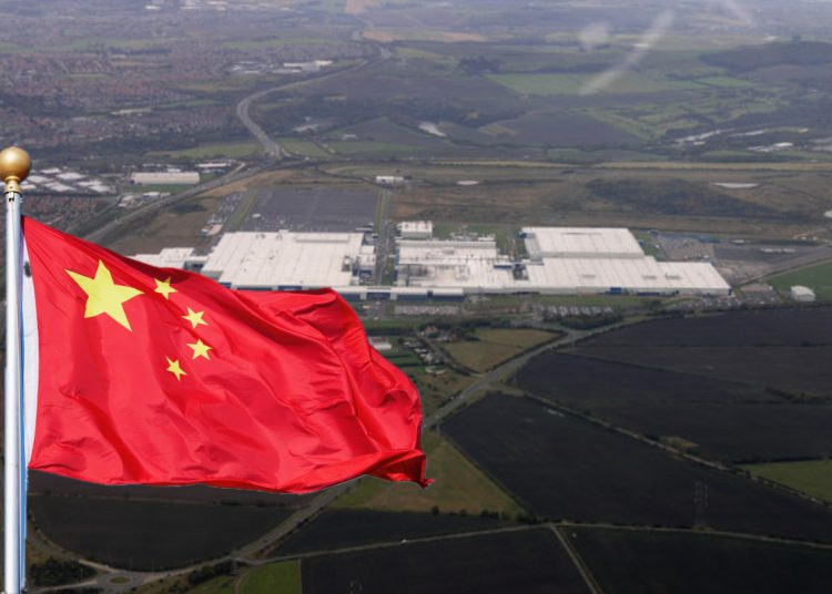 an aerial view of a large white factory building which is the Sunderland car plant for Nissan and a Chinese flag superimposed