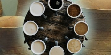 a background of ancient pots from the Beaker culture and a circle of cups of coffee on a table, each one slightly darker in shade than the last