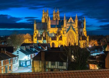 BEVERLEY, UK - DECEMBER 17, 2023: Night time view of ancient minster from elevated point in town centre with flood lights on December 17, 2023 in Beverley, Yorkshire, UK.