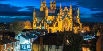 BEVERLEY, UK - DECEMBER 17, 2023: Night time view of ancient minster from elevated point in town centre with flood lights on December 17, 2023 in Beverley, Yorkshire, UK.